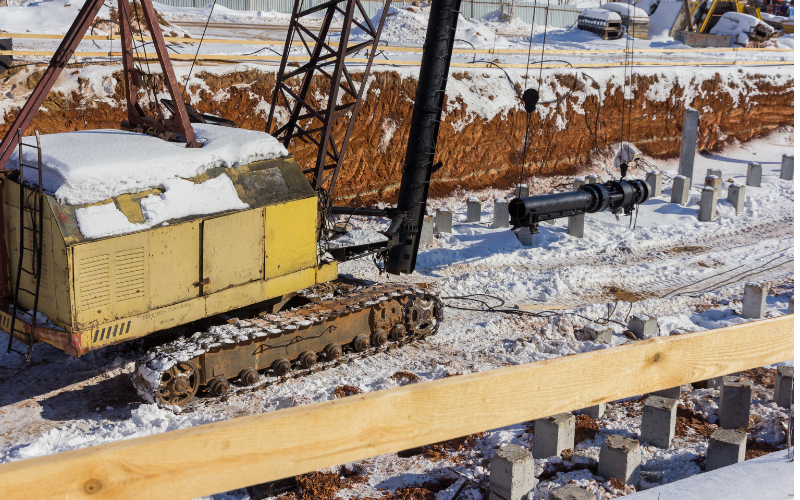 Close-up view of a pile driving machine at work on a construction project.