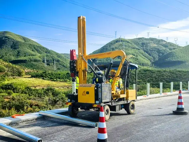 Pile driver driving piles on highway