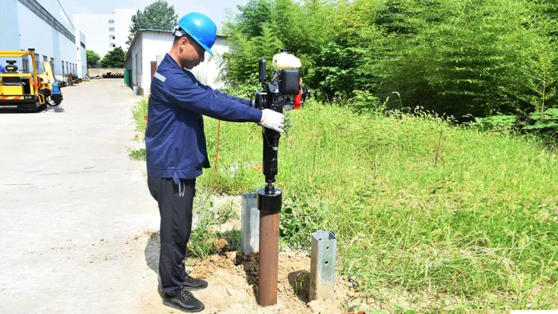 An operator is using a handheld pile driver