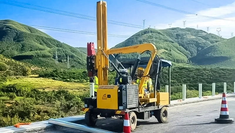 Pile driver driving piles on highway