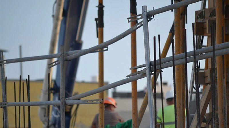 men standing at a construction facility